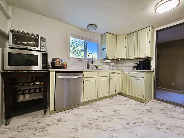 Brand new GE dishwasher, sink, faucet , backsplash, and newly painted cabinet with new hardware.