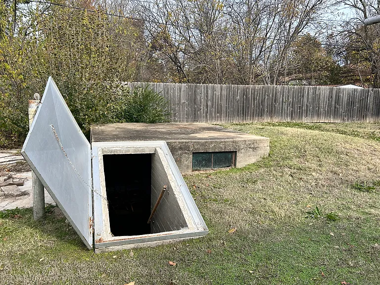 Backyard buried storm shelter.
