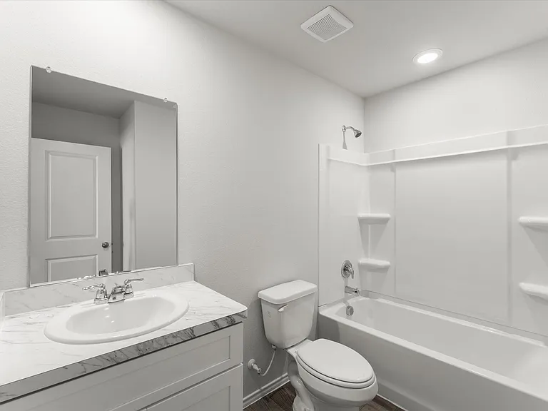 Bathroom featuring a white vanity with a laminate countertop, chrome fixtures, an oval undermount sink, and a combination tub/shower with a white surround