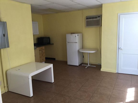 kitchen with cabinets and refrigerator and table