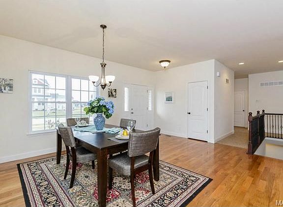 Stairs to lower level have iron spindles and stained railing