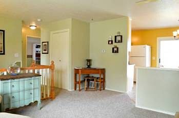 The living room space connects the dining room and kitchen to the bedrooms and bathroom down the hall.