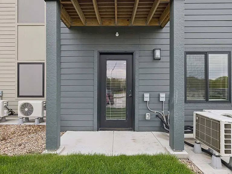 Step outside to a covered patio that offers a peaceful extension of your living space for relaxing or unwinding outdoors.