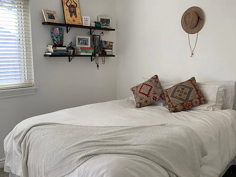 well-lit second bedroom with ceiling fan