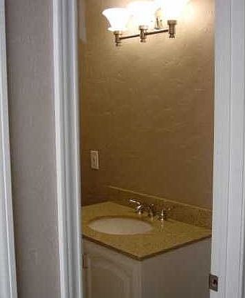 Bathroom with granite countertop and nice big mirror (not shown).