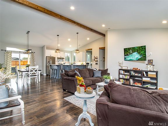 Welcome home to this big sunny great room! Perfectly on trend with vaulted ceilings, faux beam, low maintenance vinyl plank flooring, & gorgeous lighting.