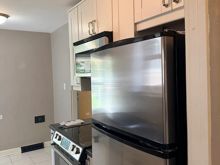 Space saver microwave, updated stove and cabinets. Windows over the sink, in the breakfast nook, and in the adjacent back door.