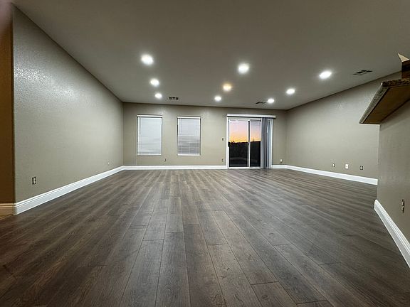 Bright, open living space with new luxury vinyl plank flooring and recessed dimmable lighting throughout.