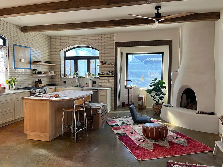 Large sun-drenched dayroom with skylights and patio doors