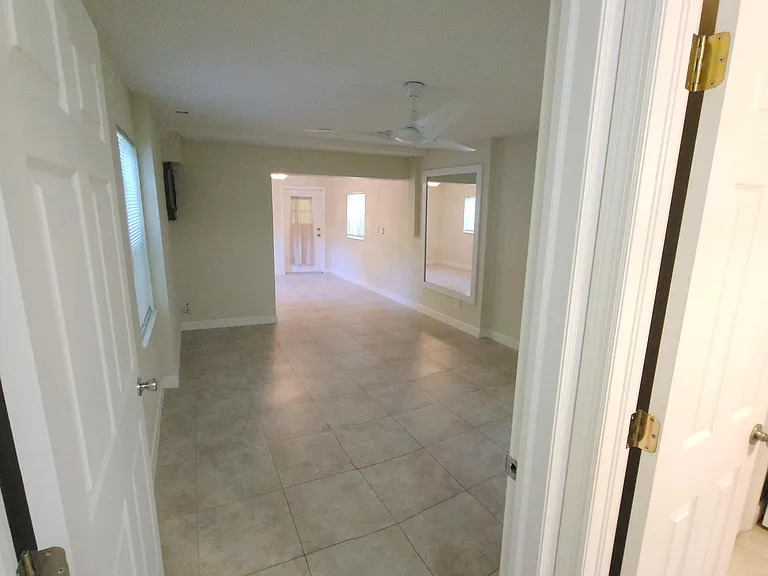 BONUS AREA! looking into "xtra" area and plus rear Den area. Utility bathroom on right with shower.