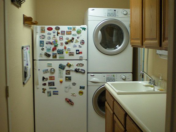 This spacious laundry room has lots of extra storage!
