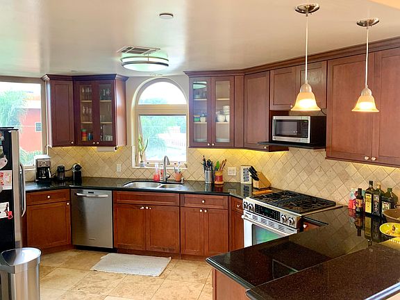 Large Kitchen with lots of counter space, storage, pantry, and waher, dryer.