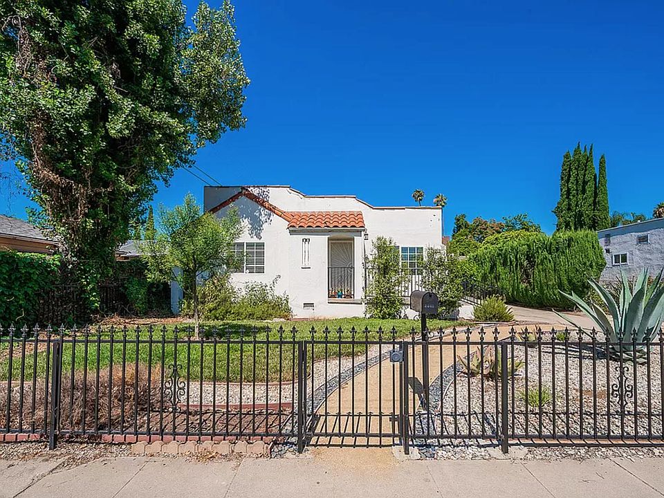 Classical gate frames charming Spanish style stucco home (front landscape redone since photo taken).