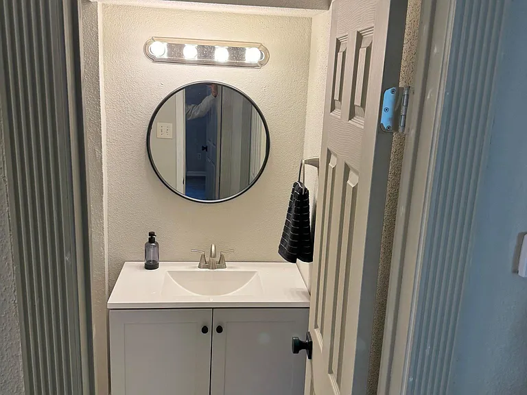 Guest Bathroom, features beautiful vanity, remodeled shower tile, and hardware.