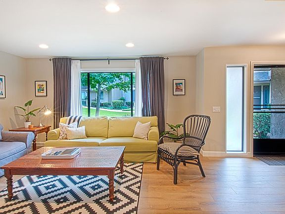 Spacious living area with large picture window and overhead lighting.