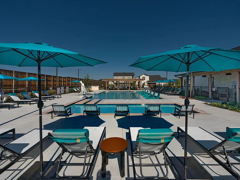 Resort-style swimming pool with lounge seating