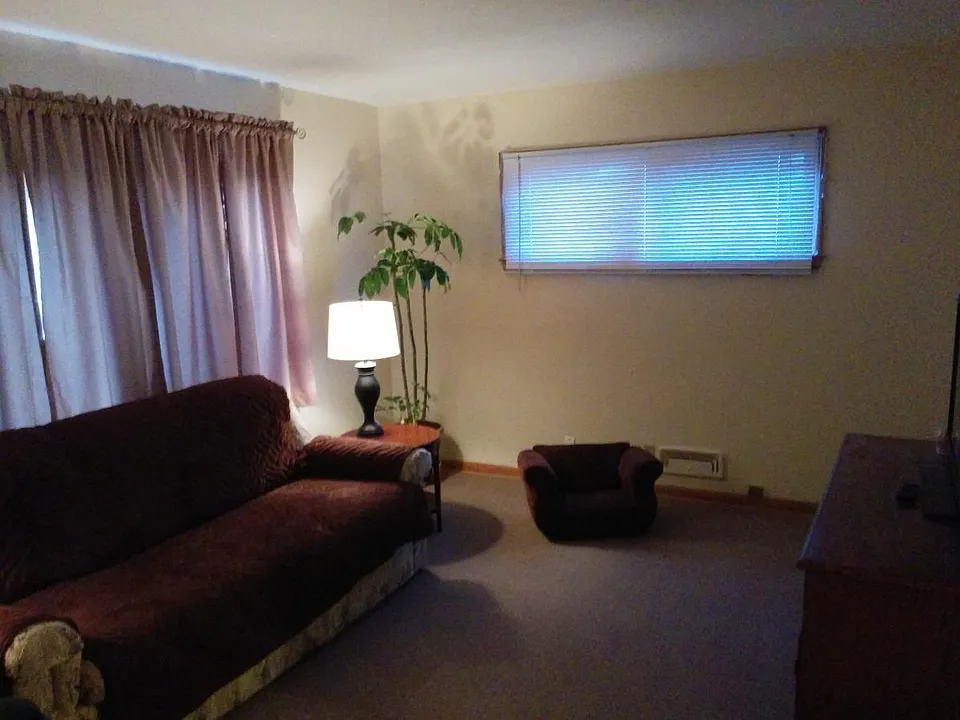 Living room w/ bow window (furn. not incl.)