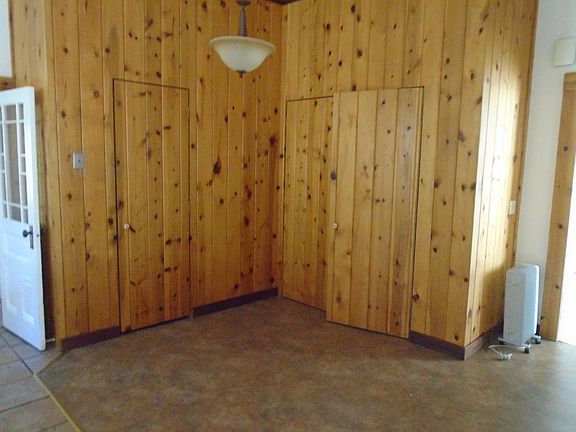 dining area, large pantry behind knotty pine door and washer and dryer on right side