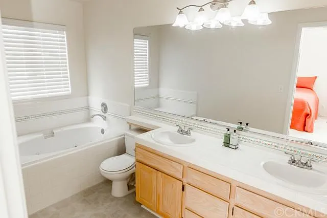 Private bathroom with double vanity and jacuzzi tub in your room. Stand-up shower is on the other side of the bathroom!