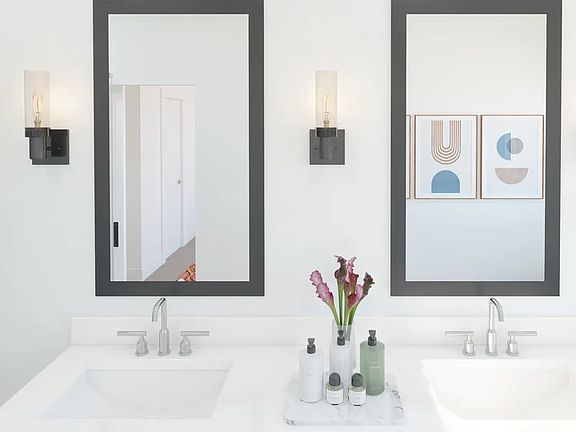 Primary bath with dual sinks, matte black mirrors and chrome fixtures