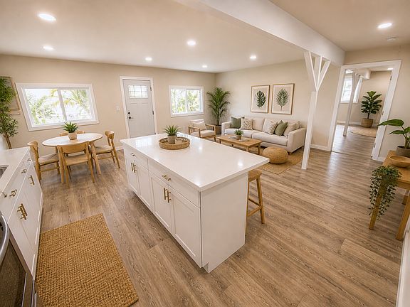 Open concept living room, dining room and kitchen. 

Photos have been digitally staged using AI.