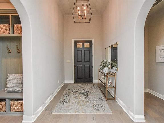 Elegant arches keep this room secluded and private with a sophisticated chandelier that brightens the hallway