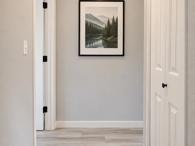 Hallway to bedrooms with linen closet on the right
