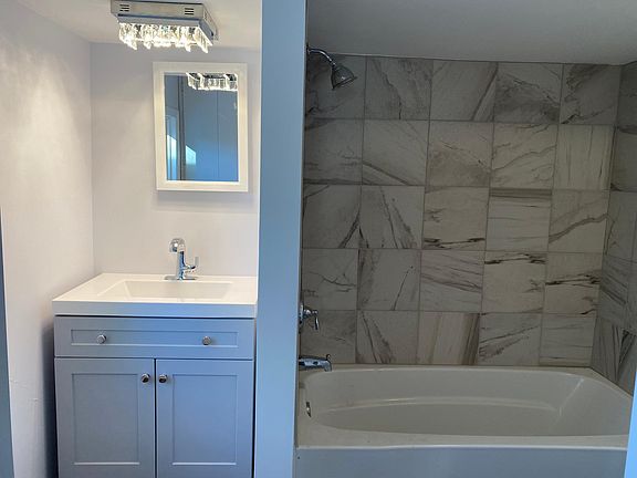 New sink, vanity, tub, tile, toilet and flooring