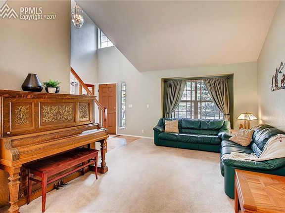 Formal living room with vaulted ceiling