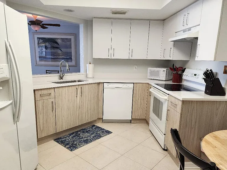 Fully stocked kitchen with all new cabinetry, pass-thru to dining area.