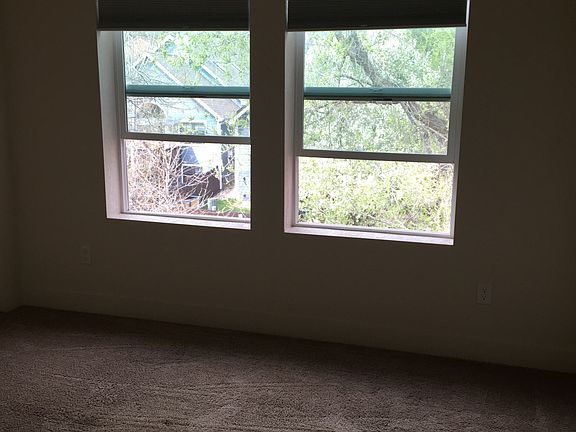 Windows to a creek and path.