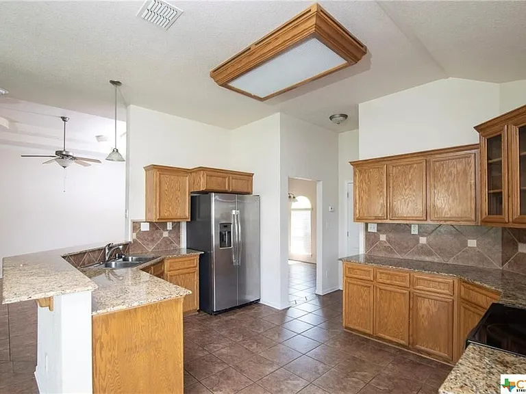 Nice roomy kitchen with granite counters.