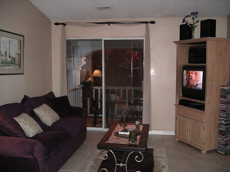 Living room with sliding glass door leading to covered porch.