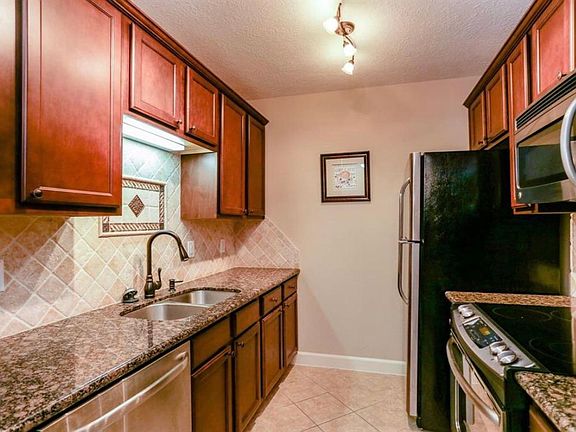 Fully equipped kitchen with stainless steel appliances.