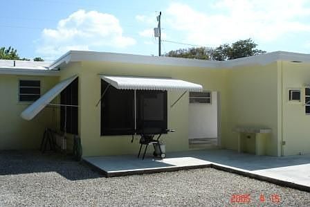 Rear of house screened porch with sliding glass doors opening into kitchen 
