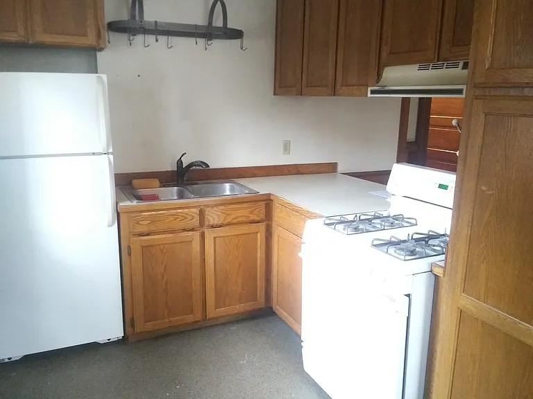 "L" Shaped Kitchen with Refrigerator, Pot/Pan Hanger Above Double Stainless Sink, 30" Natural Gas Range/Oven