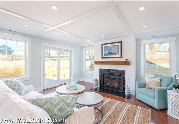 Living room with gas fireplace and French doors to a deck.