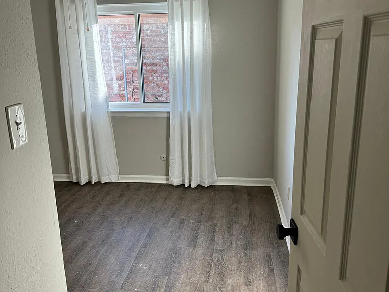1st secondary bedroom has plenty of space for a twin or queen size beds, newly installed windows, and feature LVP flooring.