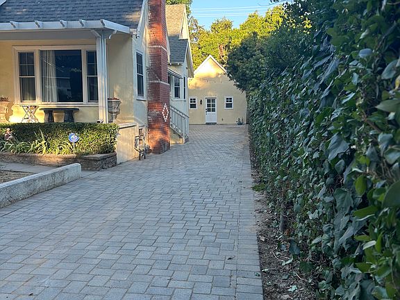 The ADU stands at the end of a long, paver driveway providing an available parking space for the tenant.