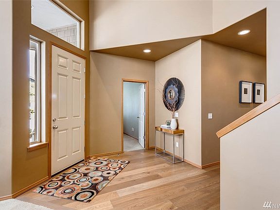 Sought after Burnstead-built home features so many interesting architectural lines!  The open door you see here leads to the den or fourth bedroom.  Notice the gorgeous floors that continue through the main hall and back through the kitchen and eating space!