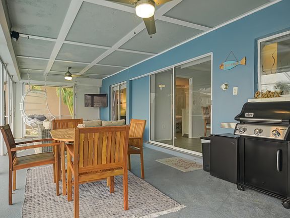 Multiple sitting areas, a grill, a TV, and an expansive lanai are great for unwinding outside in the shade or in the sun.