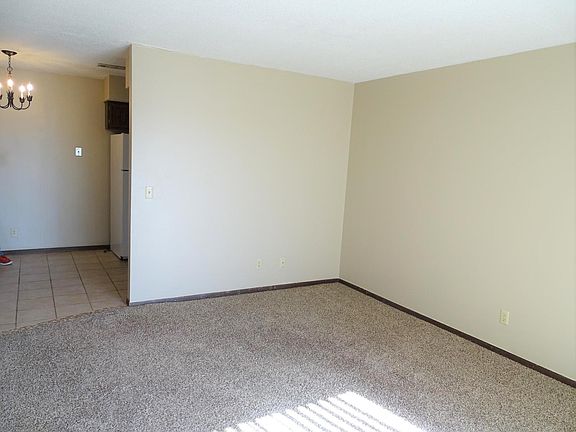 Living room with eat in kitchen behind.