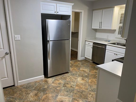 Door to garage on the left. Door to laundry room to the right of the refrigerator.