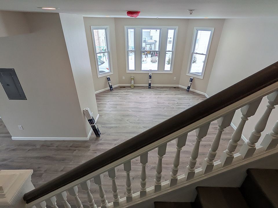 2-story apartment with stunning staircase overlooking a spacious and bright living room and dining room