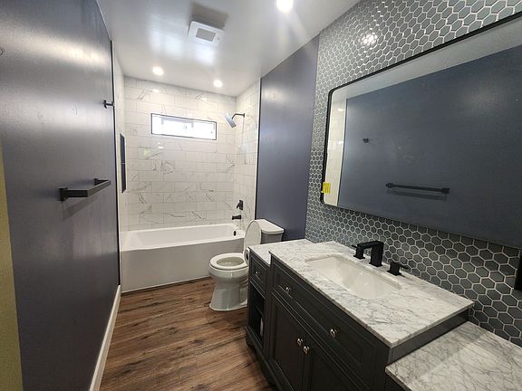 Hallway bathroom with tub