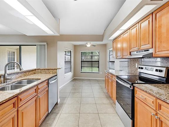 Kitchen with Breakfast nook overlooking lanai and backyard