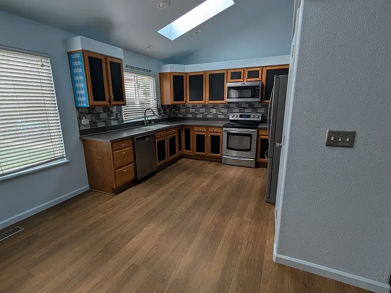kitchen with glass cooktop stove (new), microwave, dishwasher and refrigerator