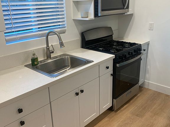 Kitchen with gas stove and microwave