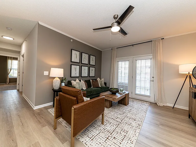 Spacious living room with hardwood-style flooring & overhead lighting