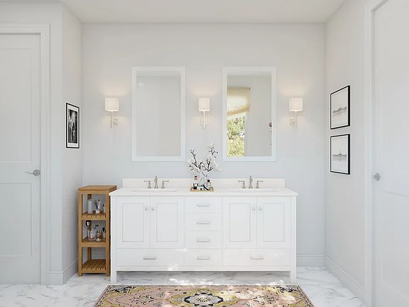 Primary bath with dual sinks and white-framed mirrors